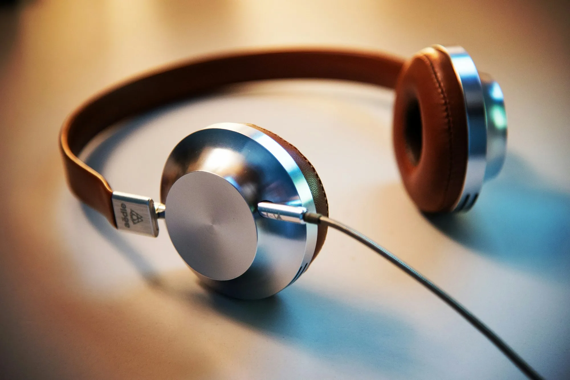 Headphones resting on a table in warm light
